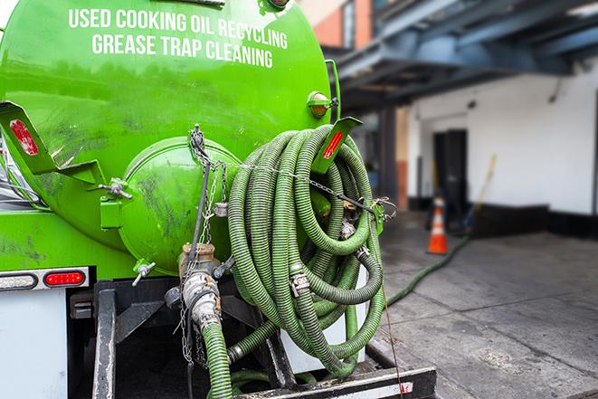 a service truck pumping grease from a restaurant's grease trap in Clifton Forge VA